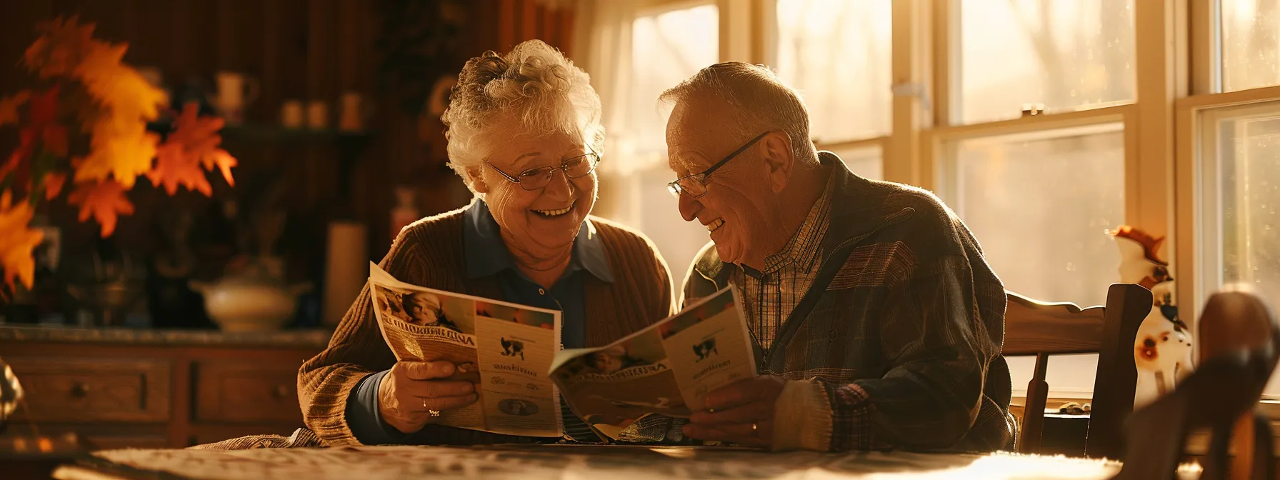 a senior couple smiling while reviewing final expense insurance brochures at a cozy kitchen table.