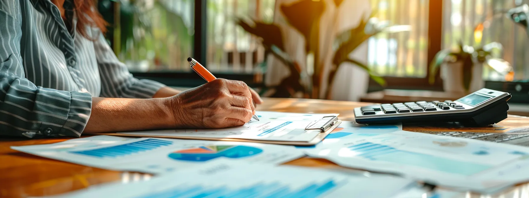 a senior woman sits at a table, reviewing a detailed final expense insurance brochure with a pen in hand, surrounded by papers and calculators, showcasing her thoughtful consideration of coverage options.