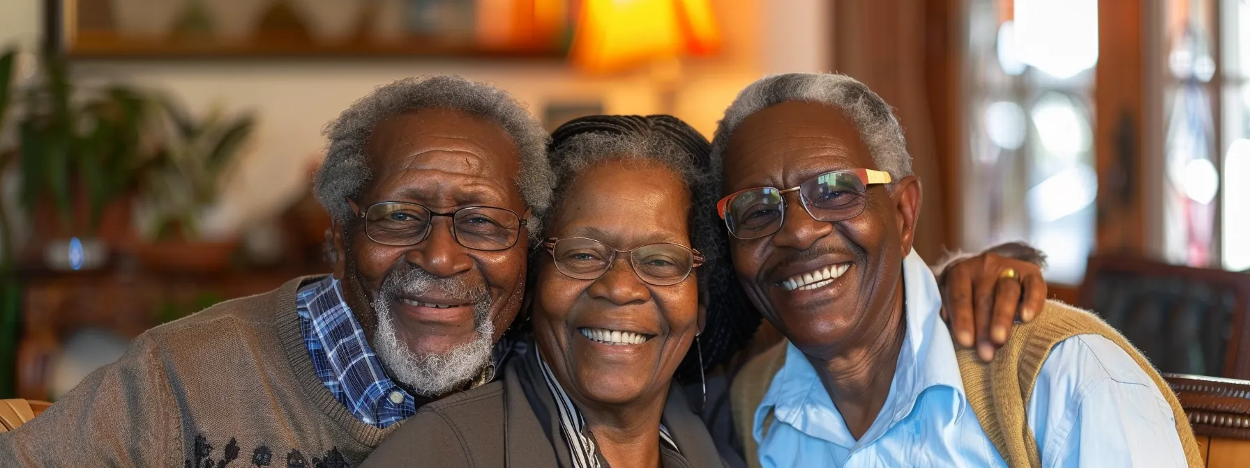 an elderly couple smiling warmly as they review final expense insurance options with a caring insurance agent.